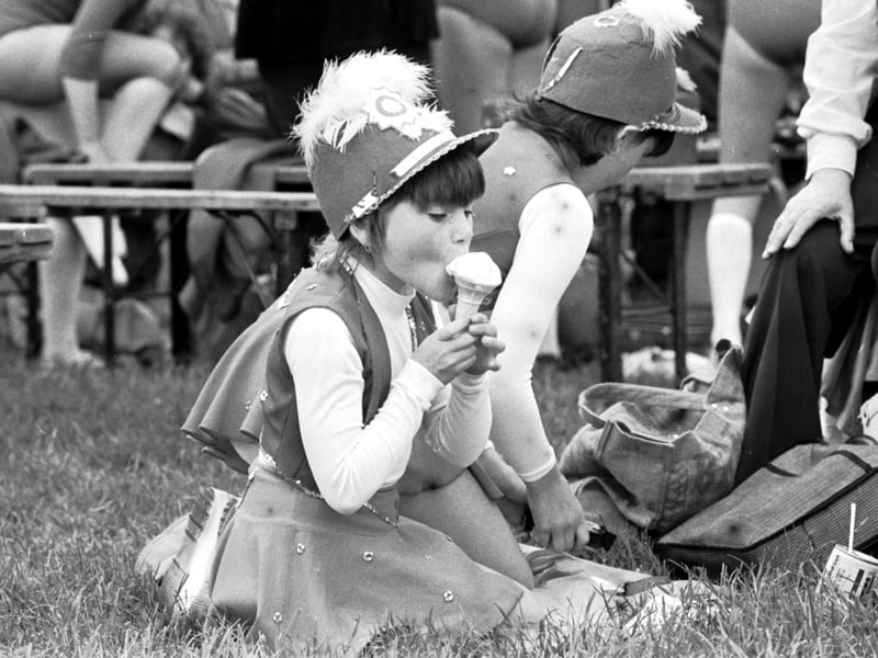 A young majorette enjoys an ice cream at Holyrood Park in Edinburgh on the Miners Gala Day 1979