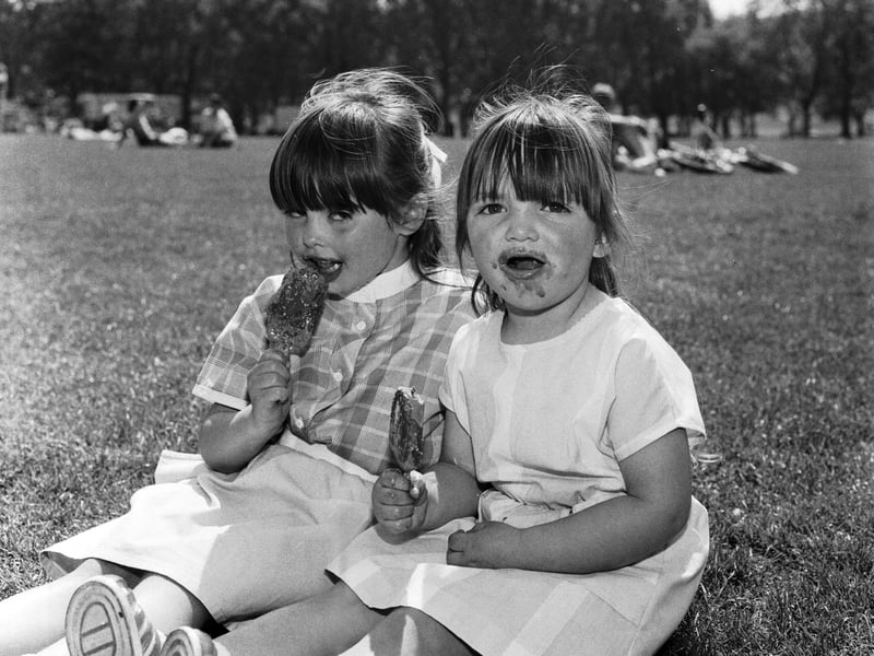 Nicola Murphy (5) and Laura Murphy (3) keep cool with ice lollies during The Meadows Festival in Edinburgh, in June 1985.