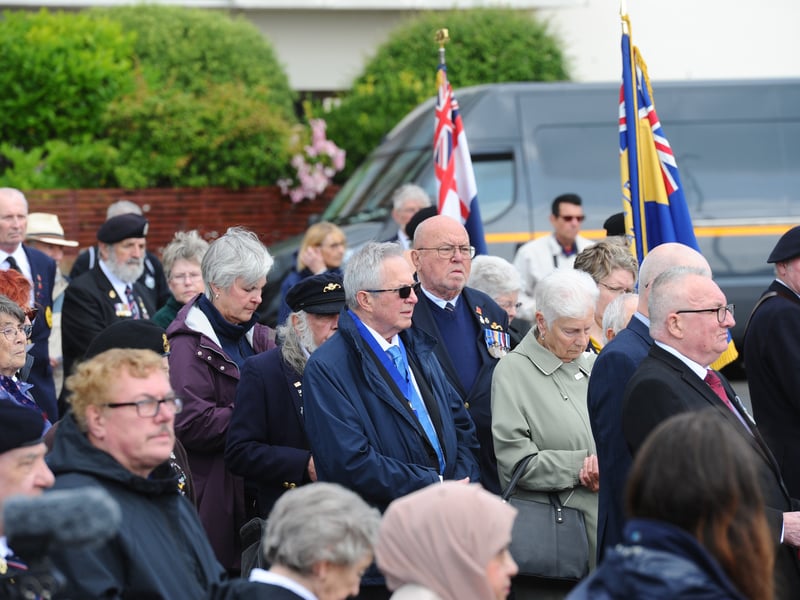 People gathered at the D Day memorial stone