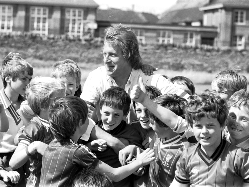Scotland international football player Denis Law is mobbed by young fans at the Soccer Summer School at Peffermill in August 1983