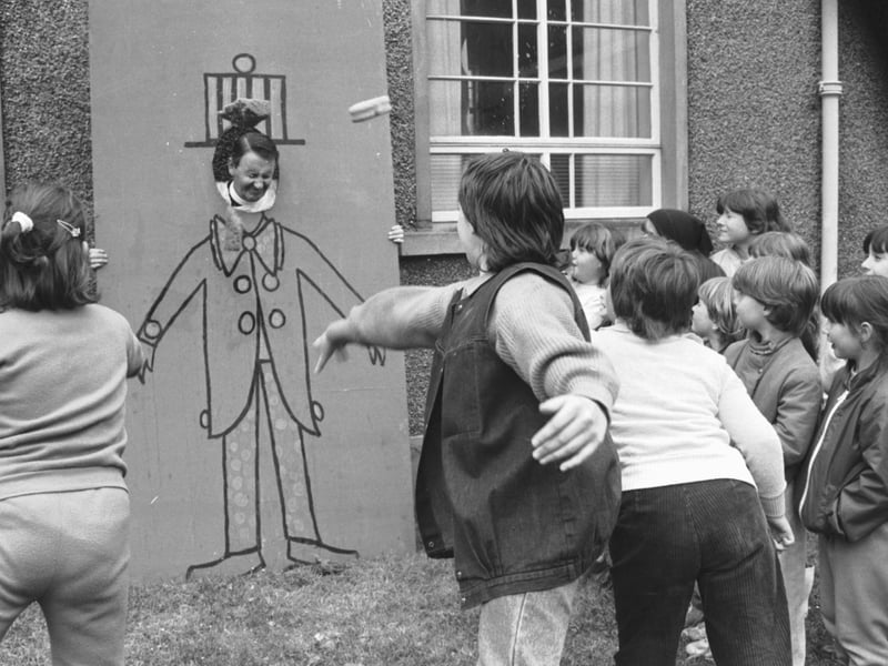 Girls from 4th Edinburgh Brownie pack throw wet sponges at the Reverend William Peat during the St Serf's summer fair in June 1978