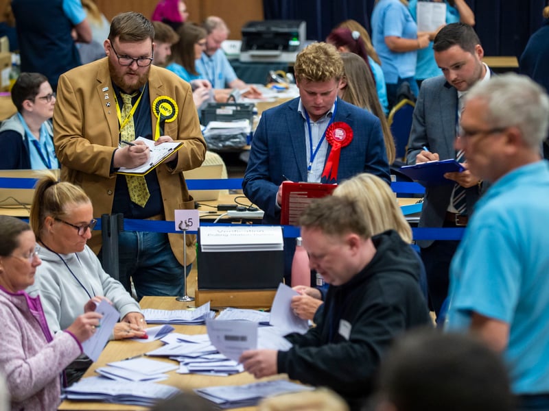 Counting agents stand at each counting station