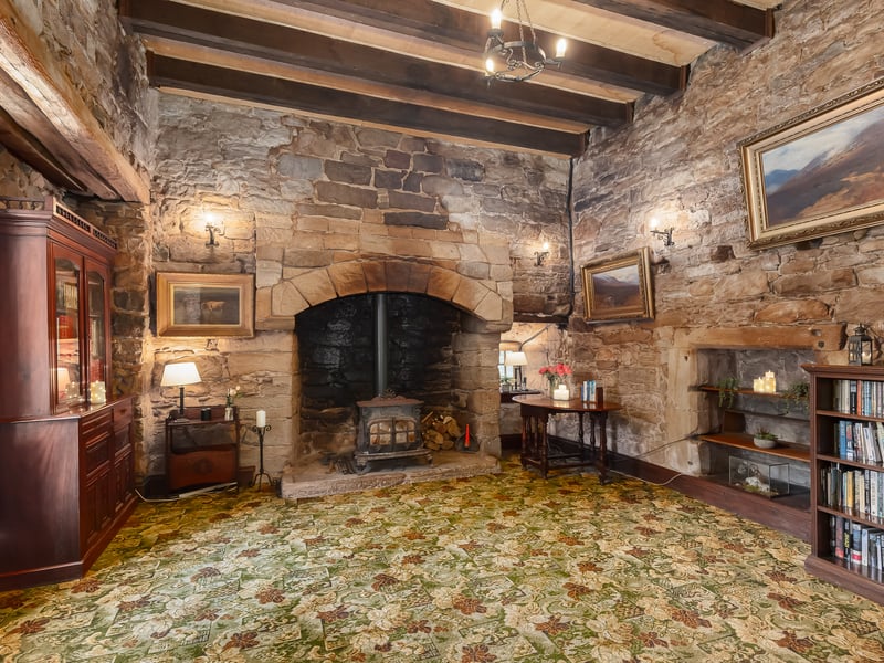 The inviting fireplace in the main reception room adds homeliness to the ancient property.