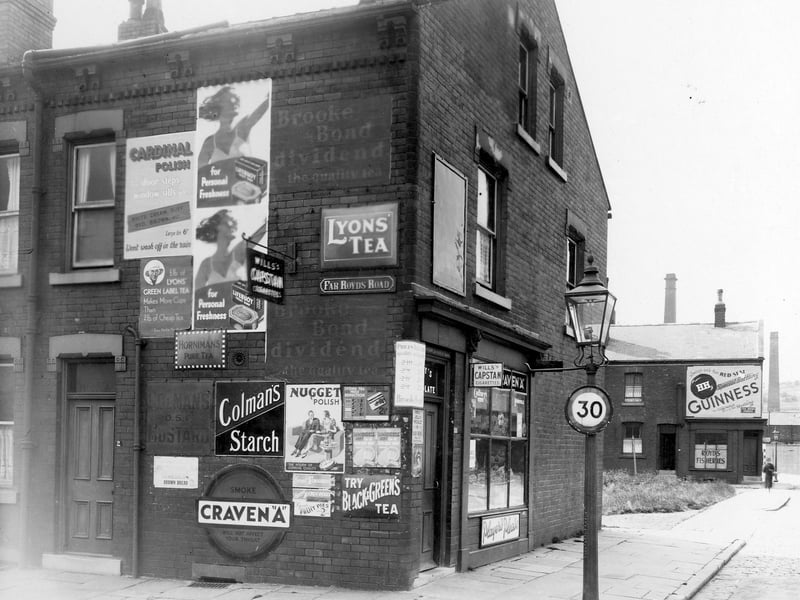 Shop on corner of Far Royds Road and Royds Lane in July 1939. Adverts on wall for Cardinal Polish, Lyons Green Label Tea, Horniman's Pure Tea, Coleman's Mustard, Lifebouy Soap, Nugget Polish, Craven 'A' etc. To the right of picture, in the distance, can be seen Royd's Fisheries, with an advert for Guinness above.