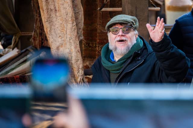 Director Guillermo del Toro waving to fans while filming Frankenstein in Edinburgh in 2024.