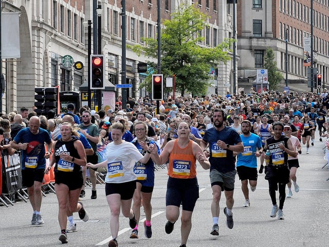 Crowds line The Headrow as runners near the finish of the Leeds 10K.
