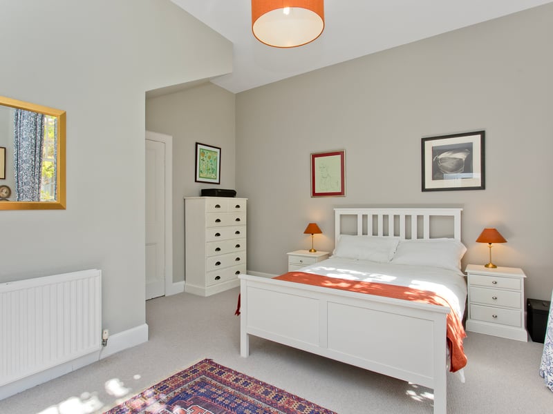 The East Lothian property's third and final double bedroom. Integrated kitchen appliances comprising an oven, a gas hob, extractor fan, fridge/freezer, dishwasher, and washing machine will be included in the sale.