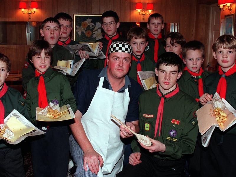 Chip shop owner Michael Harrison, of the Jolly Fryer, gets an award for the best chips in town from members of the 4th Ripon Scouts in February 1998. Presenting him with his award is senior pack leader David Vauvert, front right.