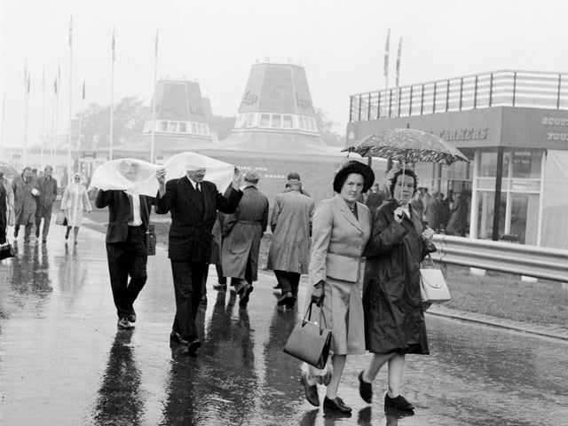 A view of the Royal Highland Show showing visitors making their way through the rain and mud.