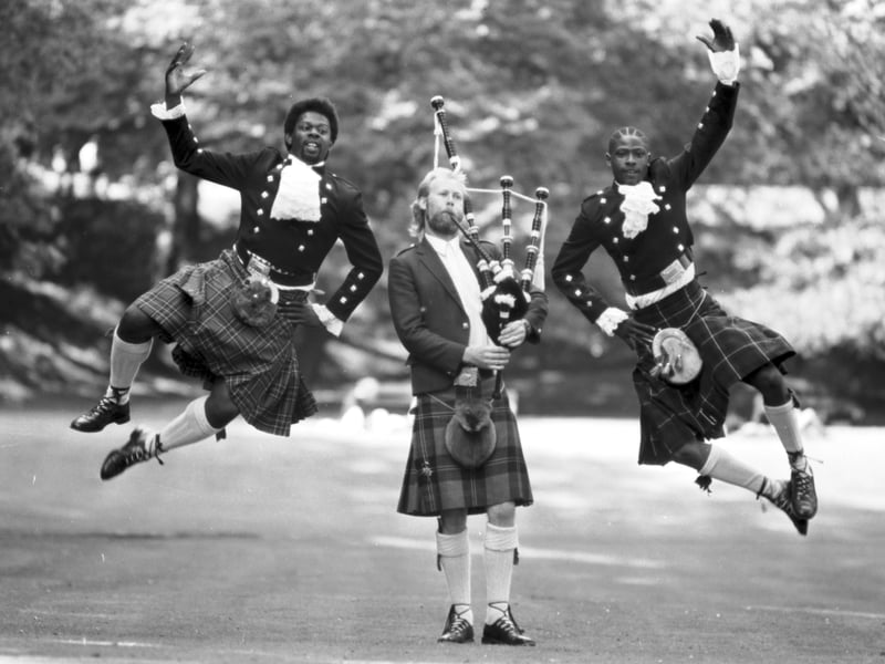 Dancers from the Black Theatre Co-Op do a enthusiastic Highland Fling with a piper. The group, which later changed its name to Nitro, were in Edinburgh to present '65 With a Bullet' at the Gilded Balloon during Edinburgh Festival Fringe 1989.
