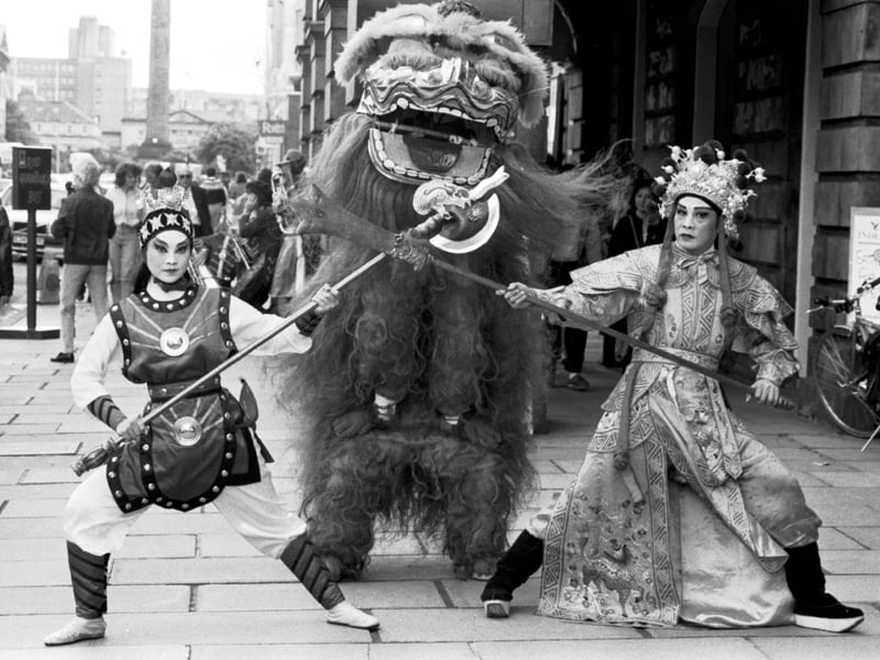 Members of the Chinese Theatre Circle in traditional costume performed the Lion Dance outside the Assembly Rooms in George Street to promote their Edinburgh Festival Fringe show, August 1988.