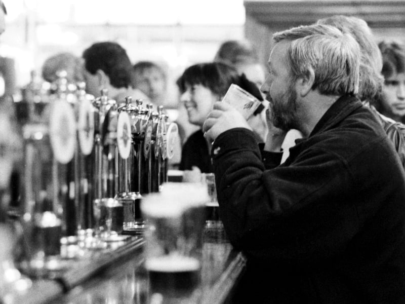 Customers enjoy a pint in the Bow Bar pub on Victoria Street, Edinburgh, in April 1990