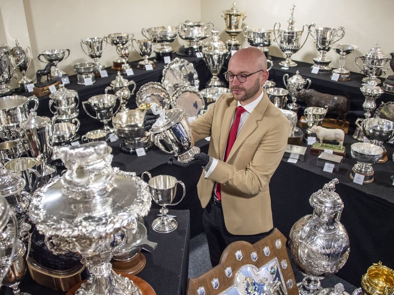 Jordan Zaccardelli polishes The Queens Cup highest honour for livestock champions. Donated by Her Majesty Queen Elizabeth II in 1960, it is awarded annually, rotating between the top winners in the livestock sections. The trophy is beautifully adorned with the royal standards, symbolising its significance and the royal endorsement of excellence at the Royal Highland Show.