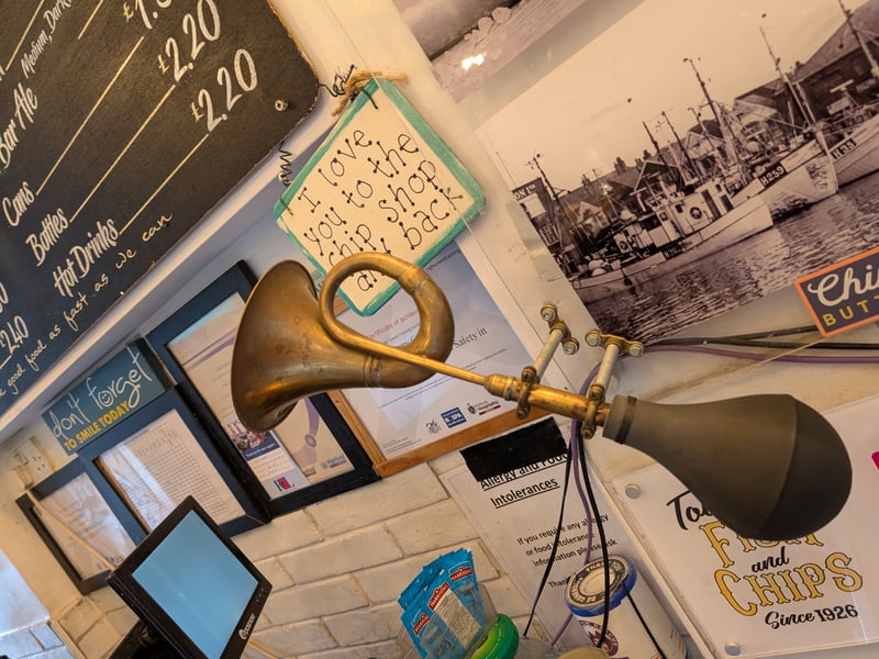 Curios from bygone ages include this bugle-esque contraption that hangs from the wall, adding character and personality to the already charming Toll Bar.