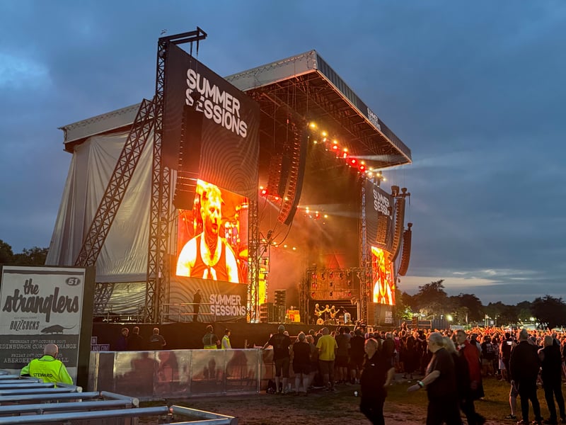 The sun sets behind the stage.