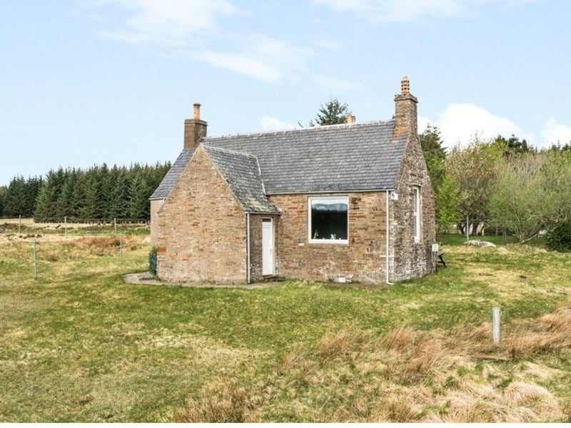 The two-floor residence is built from stone, with a red brick extension that sits under a slate roof.