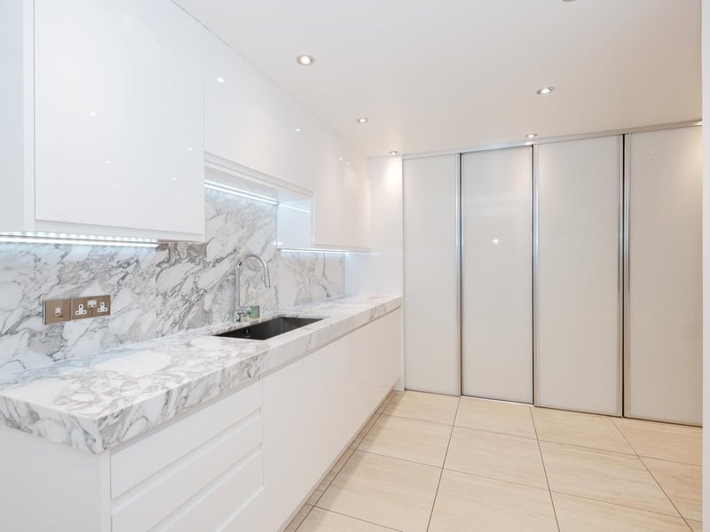 The bright and modern utility room is located on the lower ground floor.