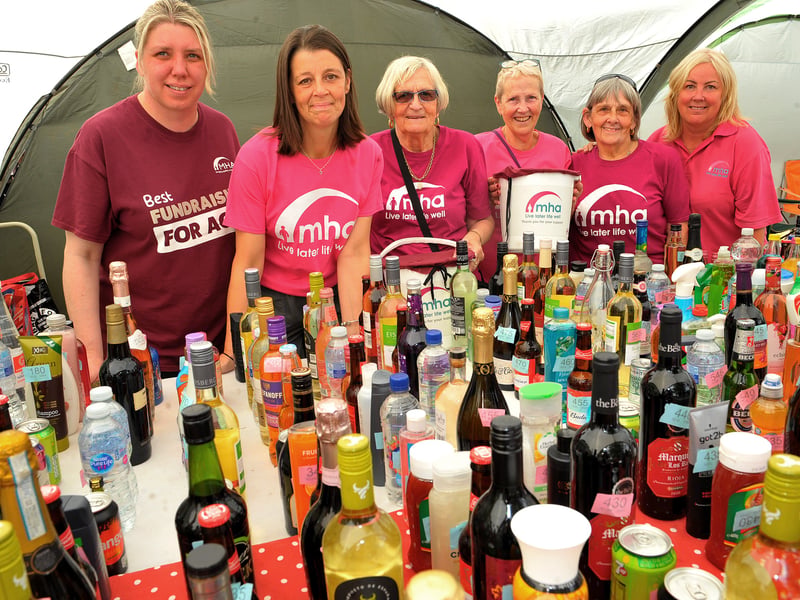 Staff and volunteers from MHA Communities, South Leeds supporting people to live later life well with their bottles for the tombola.