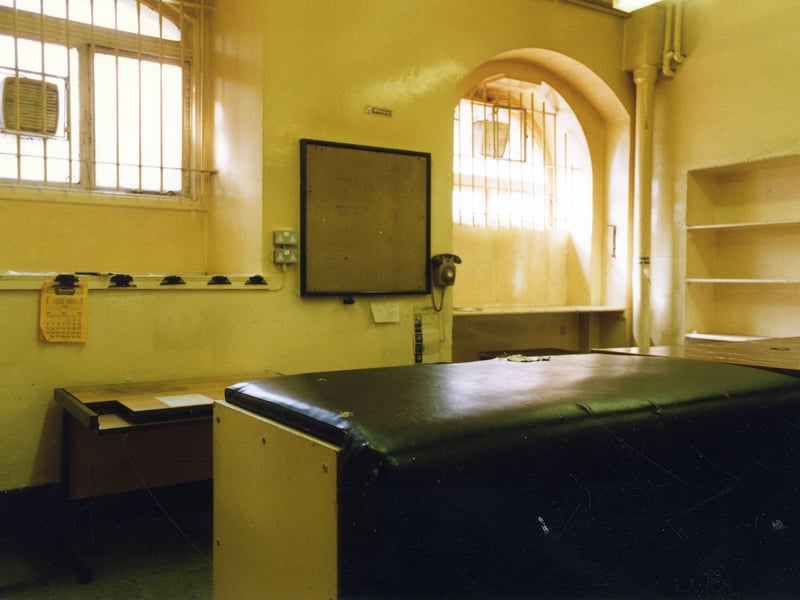 This is the view a prisoner would have had as he entered the Custody Officer's Room from the long corridor accessing the police entrance of the Town Hall. The room, seen here in 1976, is basically furnished with a heavy wooden desk to the right, and a padded desk in the foreground.