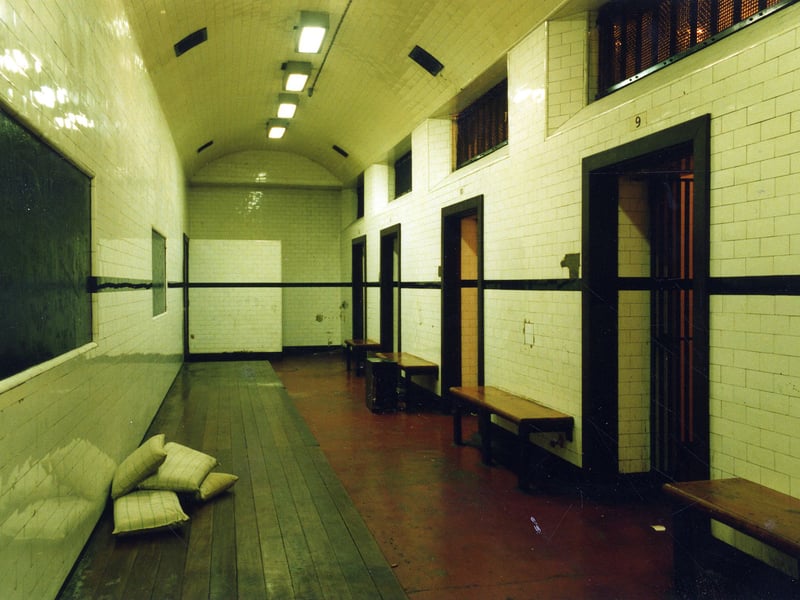 Assembly cell 7 was reserved for prisoners under the influence of alcohol and there are low benches and cushions to avoid injuries. From here there was access to Court 1 which became a Remand Court. At the far end there are toilet facilities and just before this is the entrance to the stairs to the Court on the right are side cells, from left to right, numbers 12, 11, 10 and 9.