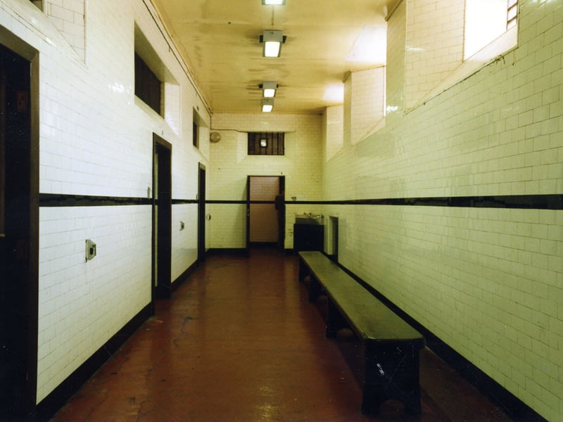 Assembly Cell 14.  Side cells, from left to right, 17, 16 and 15 can be seen on the left. The windows on the right let in fresh air and light. They look out onto Oxford Place. At the far end a doorway leads to two toilet cubicles.