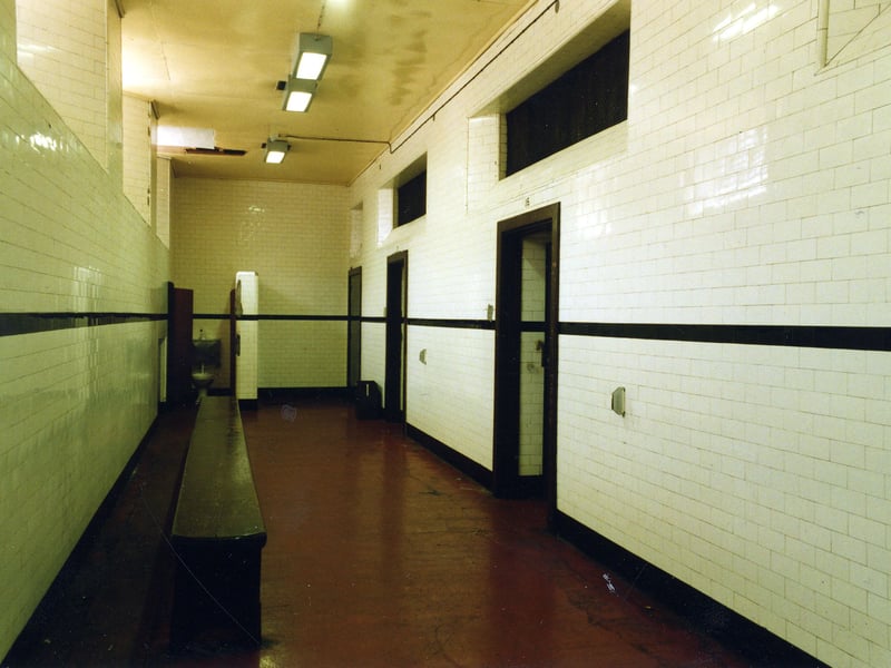  Assembly Cell 14, reserved for female prisoners. The windows to the left open on to Oxford Place and provide fresh air and light. There is a bench so that women prisoners may sit.