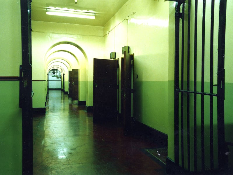 Open doors to cells are visible on the right.