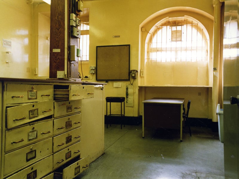 The Custody Officer's Room. The two arched windows overlook Oxford Place. Prisoners would be brought to this room to have their details documented before being transferred to cells and awaiting court appearances. The desk is to the left, beneath which use draws and cupboards.