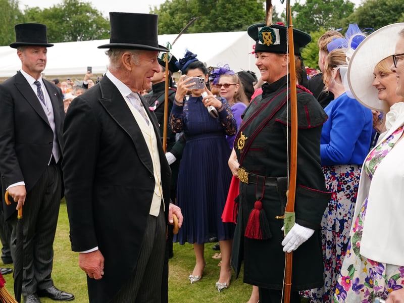 King Charles III talks with Annabel Biddulph of the Royal Company of Archers, the King's official bodyguard in Scotland, during the Sovereign's Garden Party at the Palace of Holyroodhouse in Edinburgh.