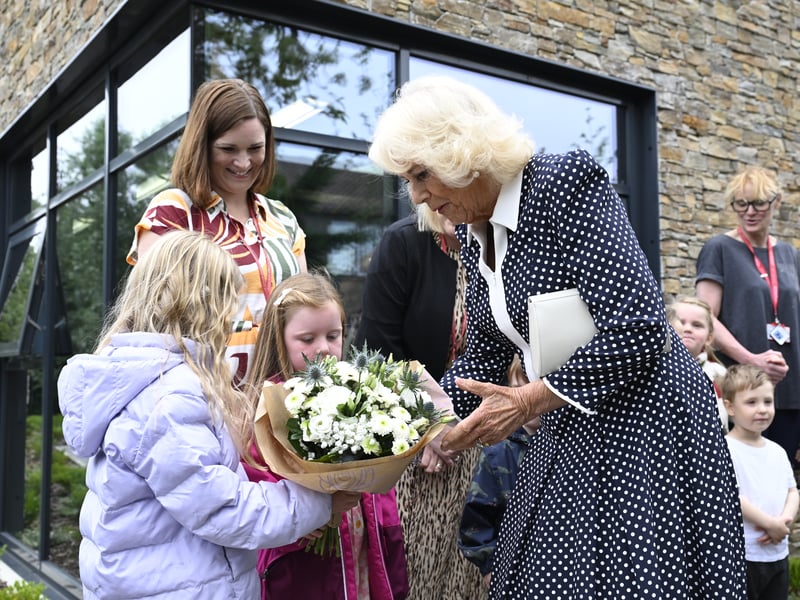 Queen Camilla receives a bouquet of flowers as she leaves after opening Ratho Library in Newbridge, Edinburgh, celebrating a partnership with Edinburgh International Book Festival and Edinburgh City Libraries as part of her trip to Scotland for Holyrood Week.