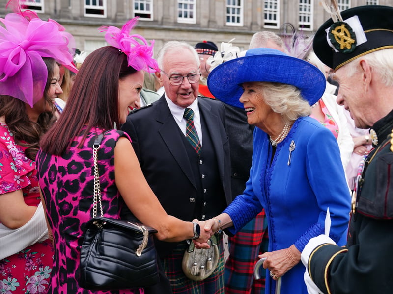Queen Camilla meets guests during the Sovereign's Garden Party at the Palace of Holyroodhouse in Edinburgh.