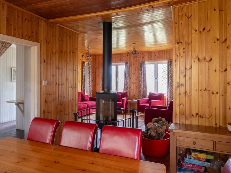 The sitting room of Oakwood Cottage is located on the ground floor alongside the kitchen, bunkroom, three double bedrooms and a family bathroom. It also includes a wood-burning stove.

