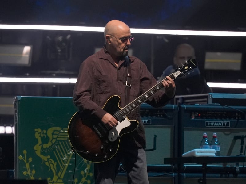 Paul 'Bonehead' Arthurs of Oasis takes on stage at the Principality Stadium, Cardiff.