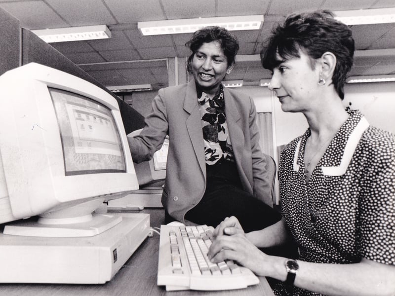 A student and pupil at work in the Computer Studies department at Park Lane College in August 1995. The course was scheduled around school hours to help mums and was there was a college creche catering for children aged between two and five.