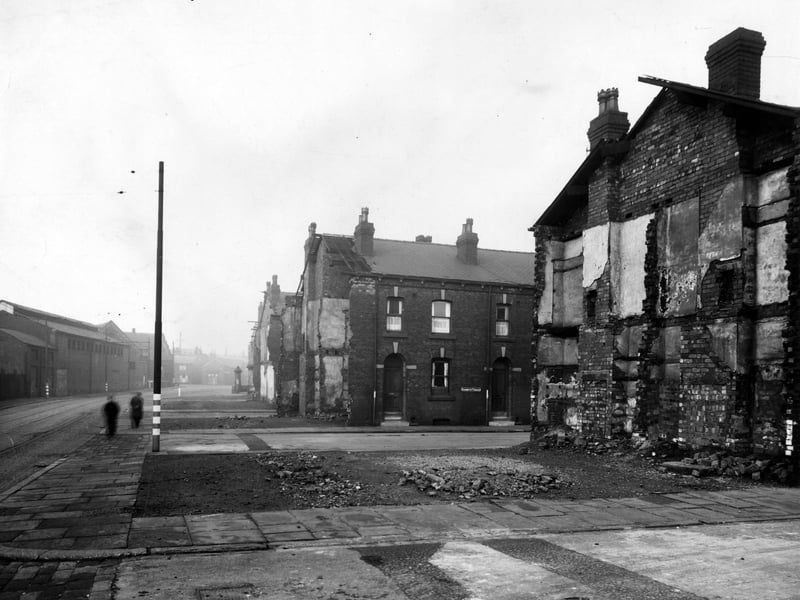 Looking north up Balm Road, with Barmouth Terrace in the centre. The end houses on all the rows of back-to-back houses have been demolished. On the right, the inside of the houses is revealed, showing chimney flues with bricked up fireplaces, interior walls, floor levels and exposed roof timbers. Pictured in November 1943.
