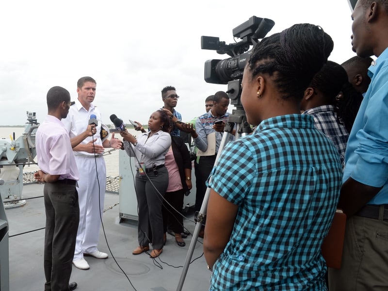 HMS Orwell, a River-class minesweeper, was sold to Guyana in 2001 and renamed Essequibo. Pictured: Lieutenant Commander Richard Hewitt salutes 24 Commonwealth war dead during a visit to the Caribbean nation.