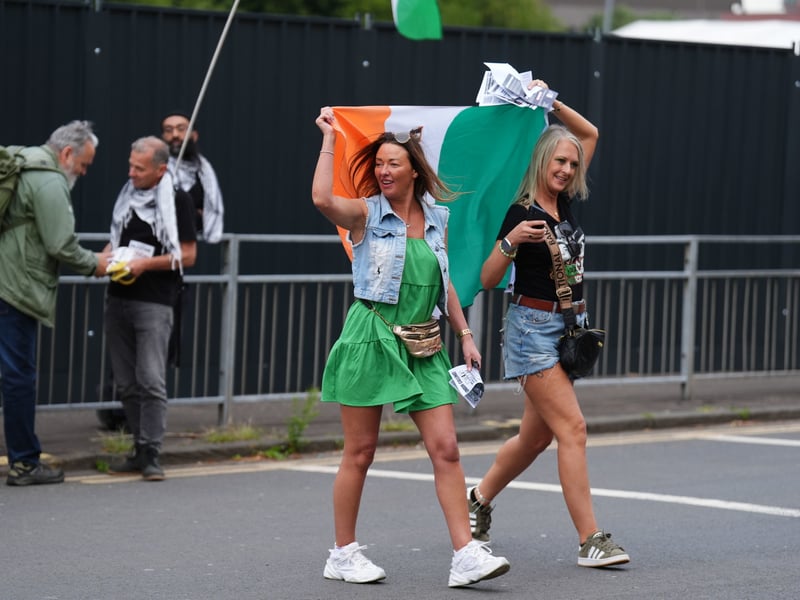 Fans brandish the Irish flag as they arrive for Kneecap's Glasgow gig at the O2 Academy.