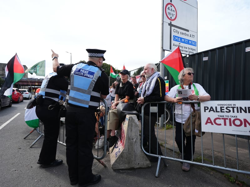 Pro-Palestinian protestors speak to police officers outside Kneecap's O2 Academy gig in Glasgow.