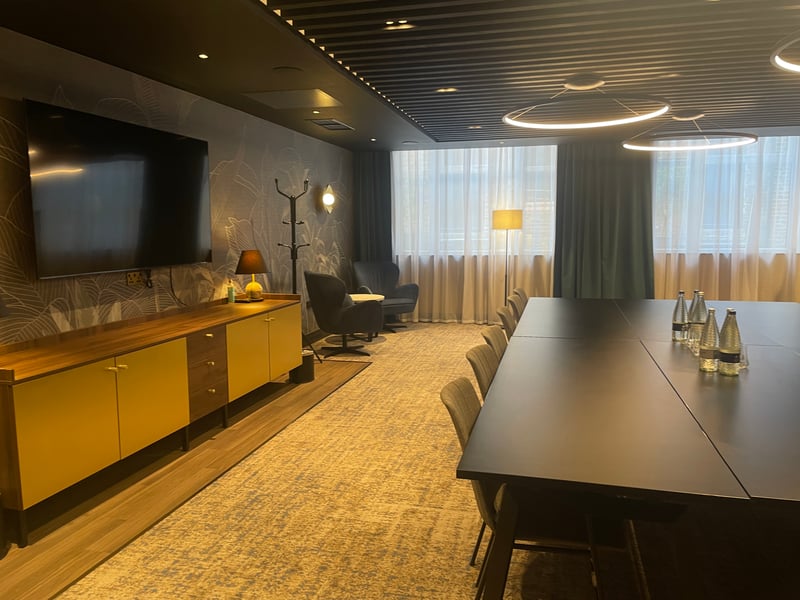 The meeting rooms for the hotel follow a calmer blue palette, with dark rich timbers and brass accents.