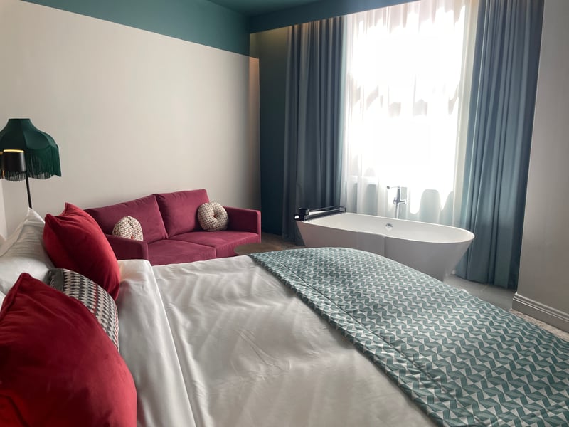 This spacious and stylish room features a large bathtub in the centre.
