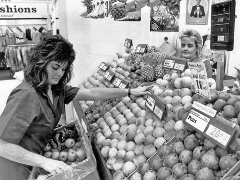 Restocking the fruit stall at Crystal Peaks Indoor Market, Sheffield, in August 1988