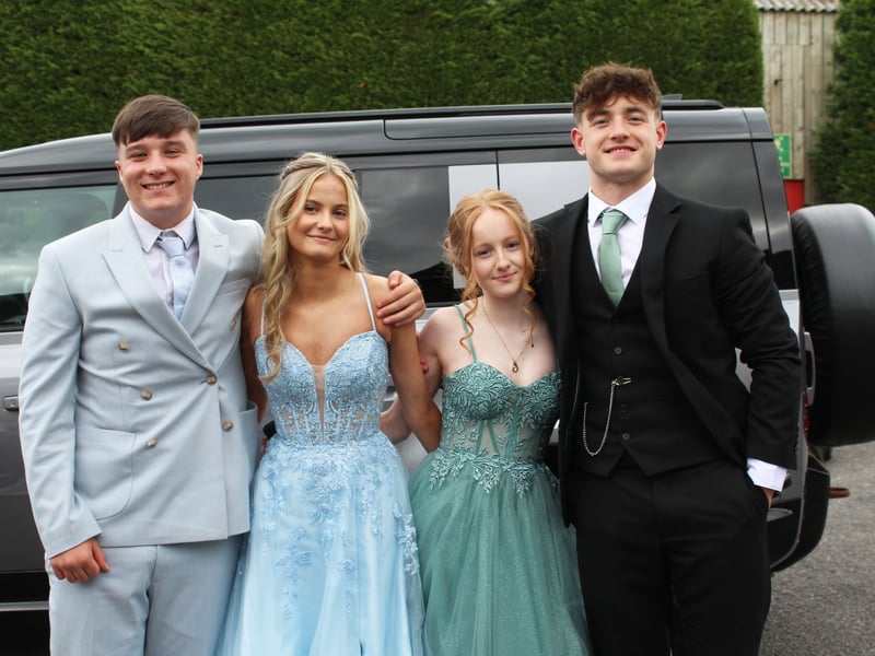 Two prom couples pose for a photo