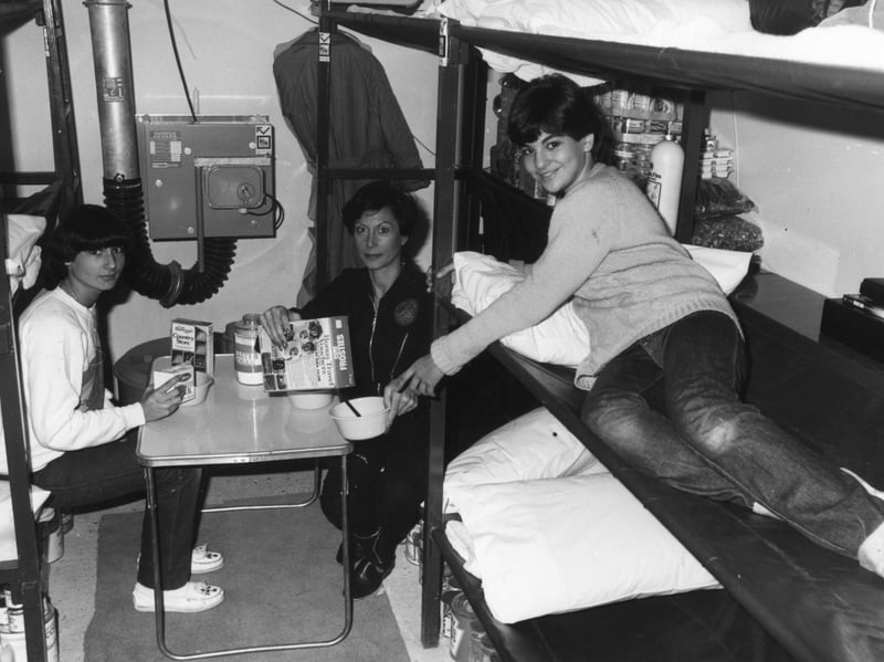 Phyllis Millet and her daughters Roberta and Katie (right) having breakfast in their underground nuclear shelter during a five-day trial in October 1980