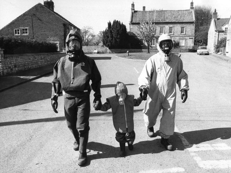 A family wearing anti-radiation suits in the village of Wellingore, Lincolnshire - the home of Civil Defence Supply, a mail order business that supplies products to survive a nuclear attack - in May 1980