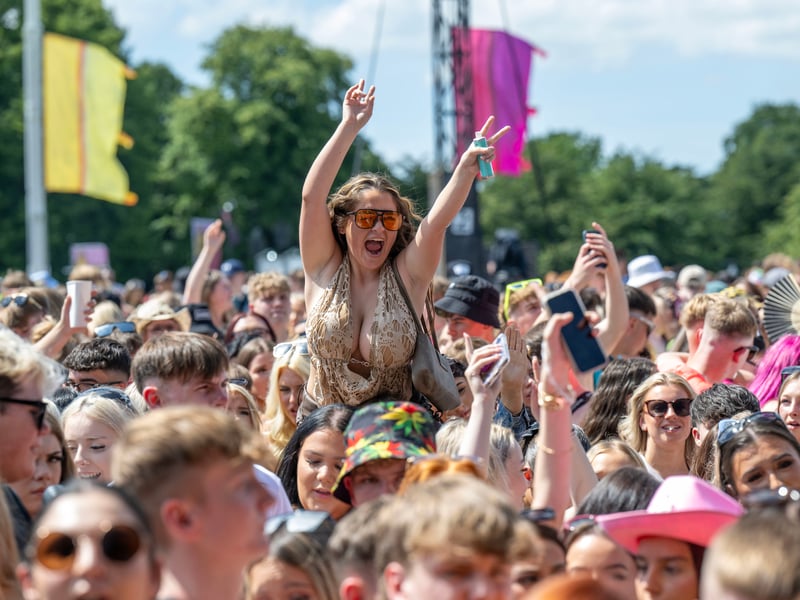 Revellers watch James Bay perform on stage.