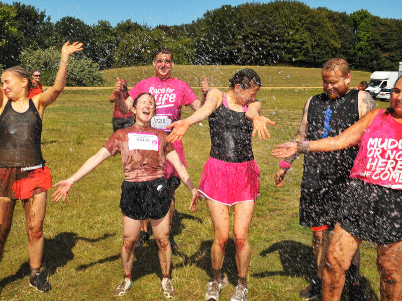Runners all muddy and wet as they cool down after the race.