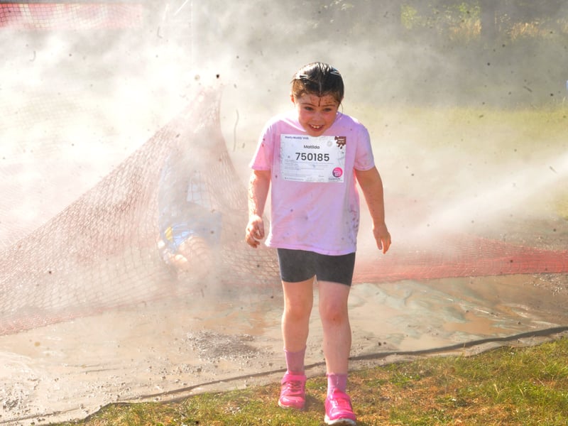 Matilda Exley gets a soaking during the Pretty Muddy Kids Race For Life.