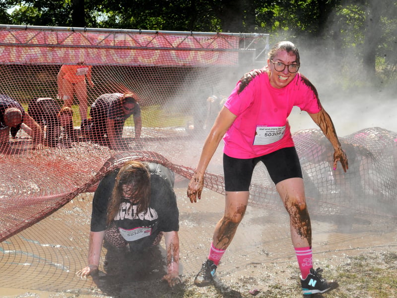 Runners in the Pretty Muddy Race For Life muddy and wet.