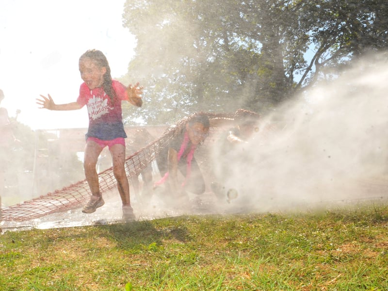 The kids get a soaking during the Pretty Muddy Kids Race For Life.