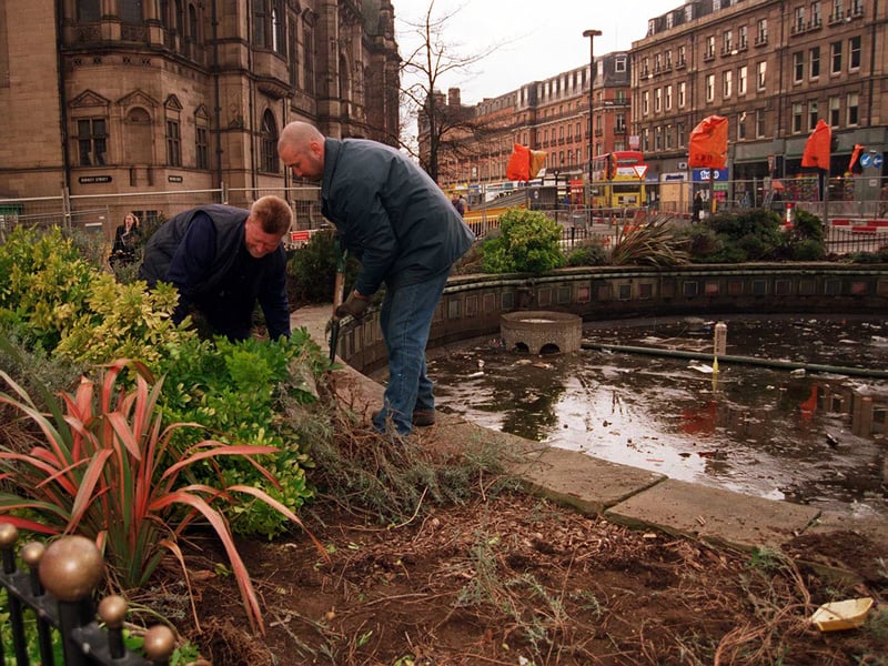 Workers remove flowers (for replanting) from Goodwin Fountain, at the top of Fargate, as Sheffield Council prepares to demolish it in 1998